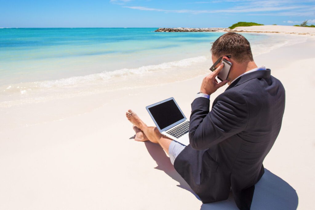 Businessman working on the beach