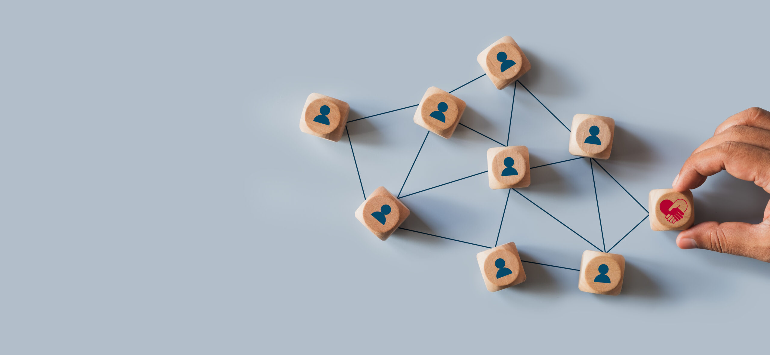 Hands holding wood cube with empathy leadership icon. symbolizing supportive management, trust building, human centered teamwork, workplace connection for corporate use. Empathy in leadership concept